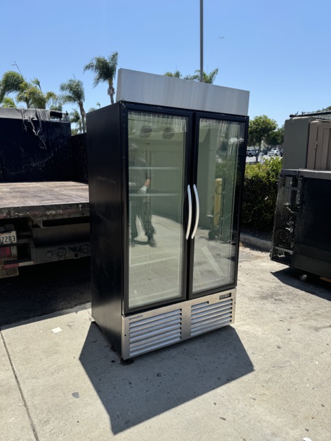Glass-door display refrigerator staged on a driveway in San Diego